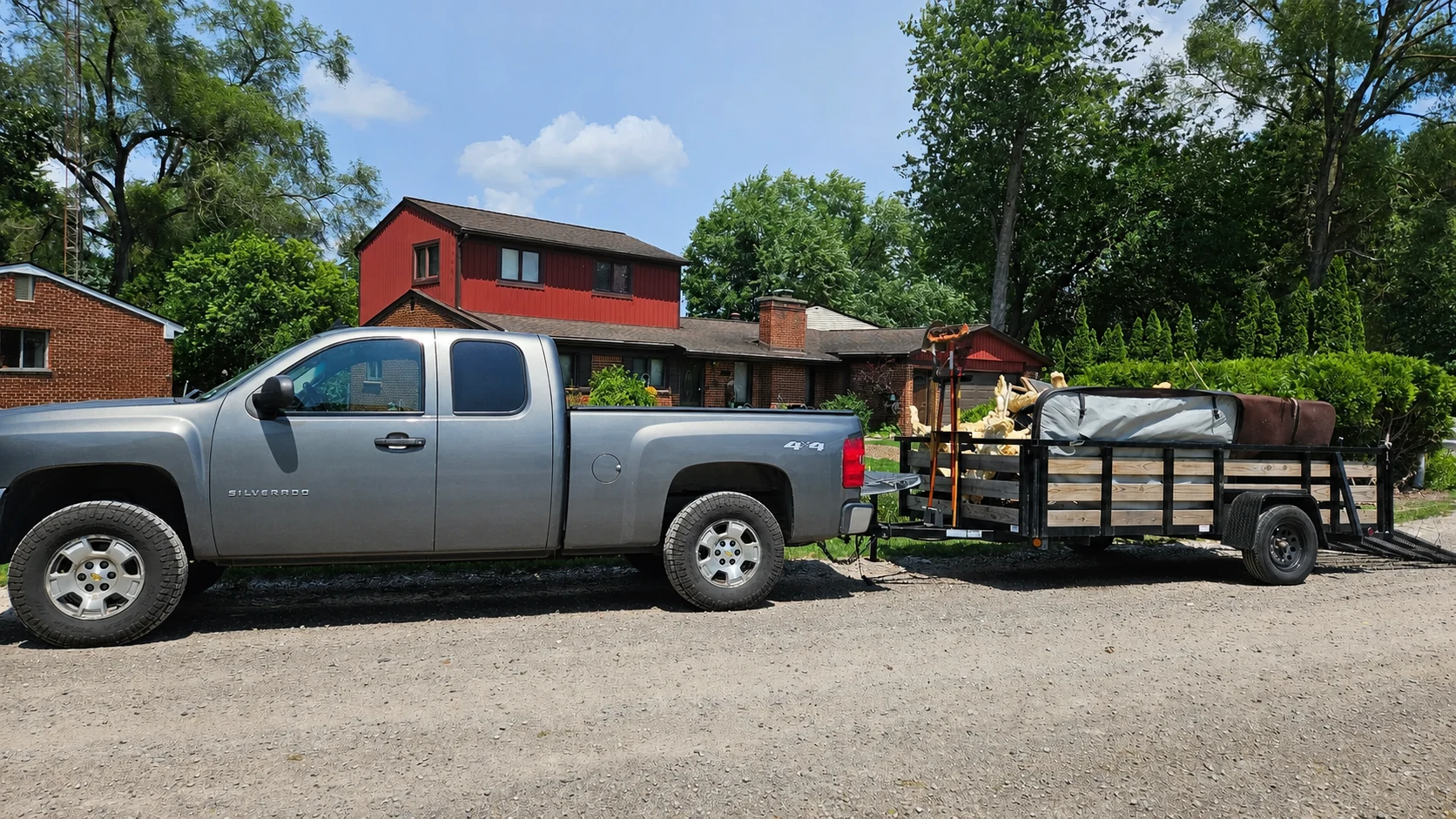 Remove It Right Demo truck and loaded debris trailer after the hot tub and fence removal
